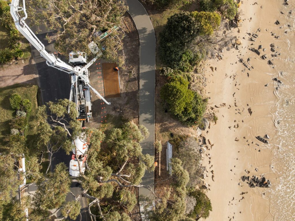 Overhead view of a Regor boom pump placing concrete for the Hawley coastal pathway