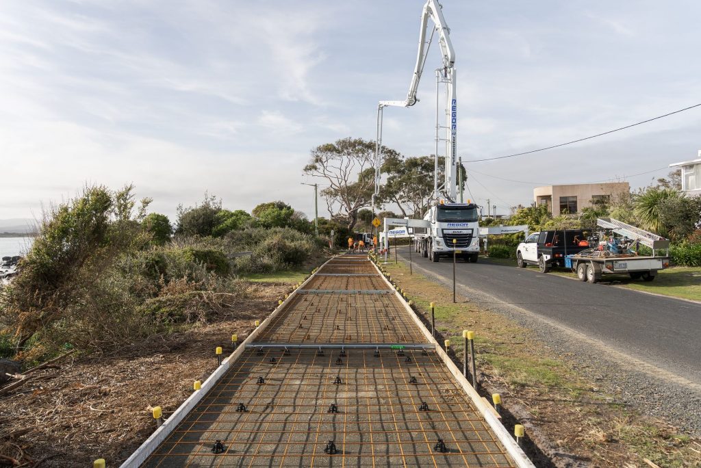 Reinforced coastal pathway ready for concrete with the Regor boom pump set up roadside