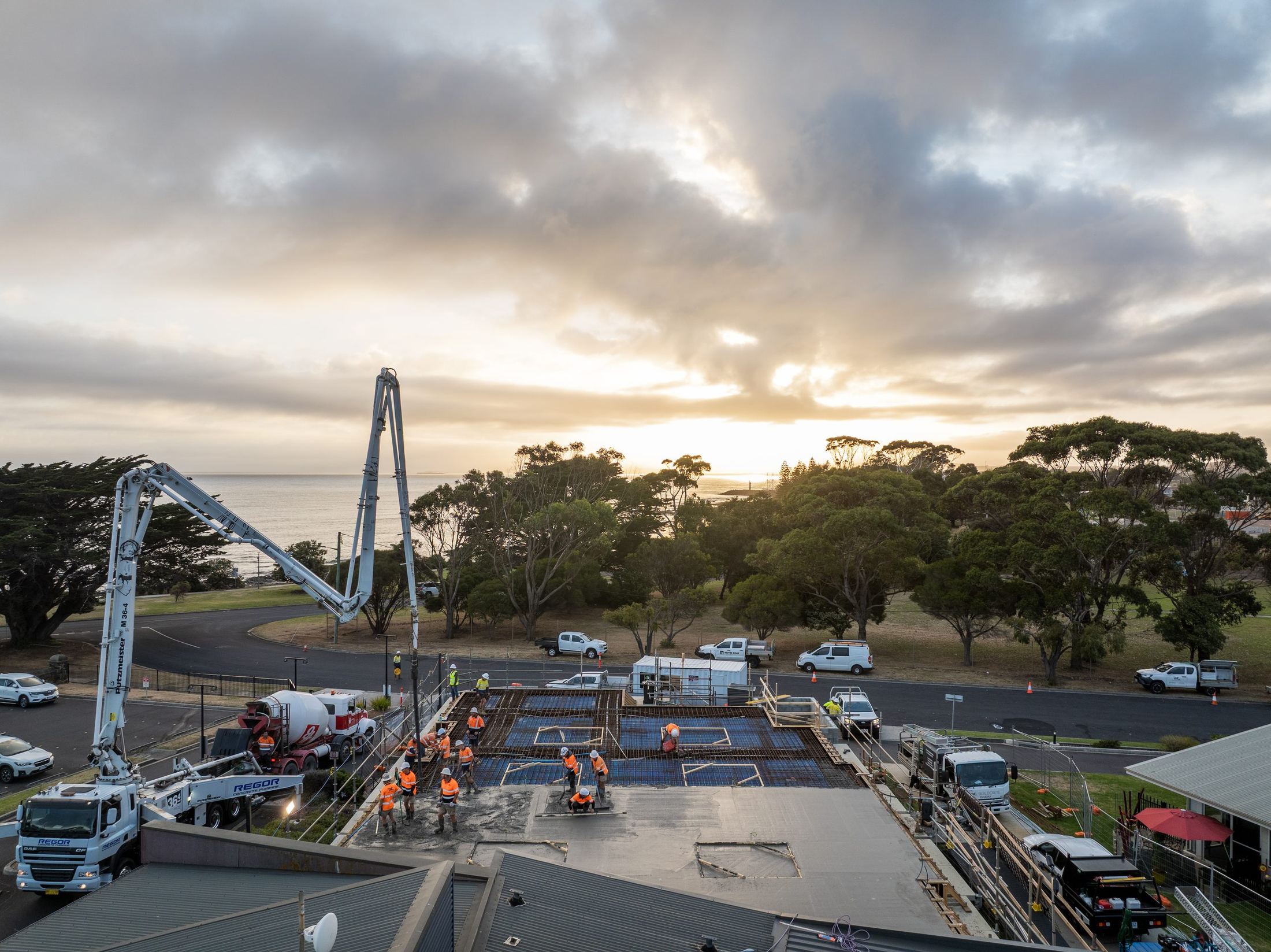 Regor boom pumps on a suspended slab pour at Meercroft at sunrise
